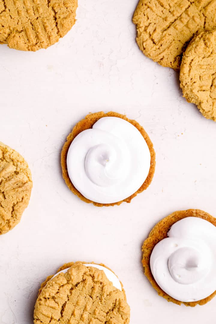 Sandwiching peanut butter cookies with marshmallow filling.
