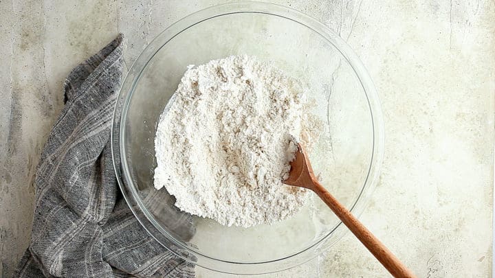 Flour, salt, yeast, and warm water in a large glass mixing bowl.