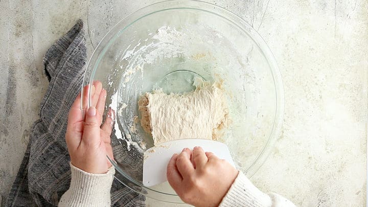 Folding ciabatta dough over onto itself.