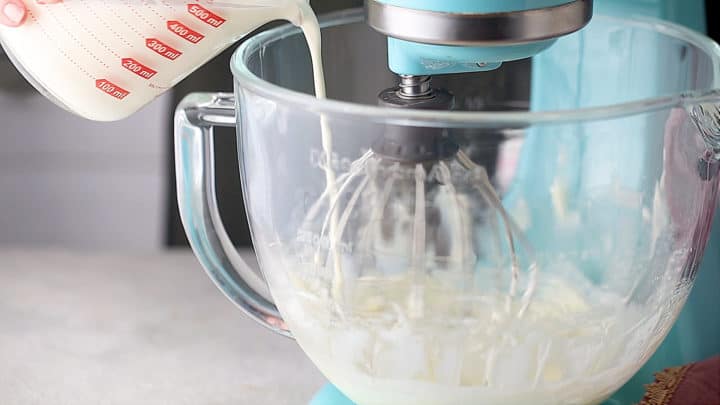Adding cream slowly to cream puff filling.