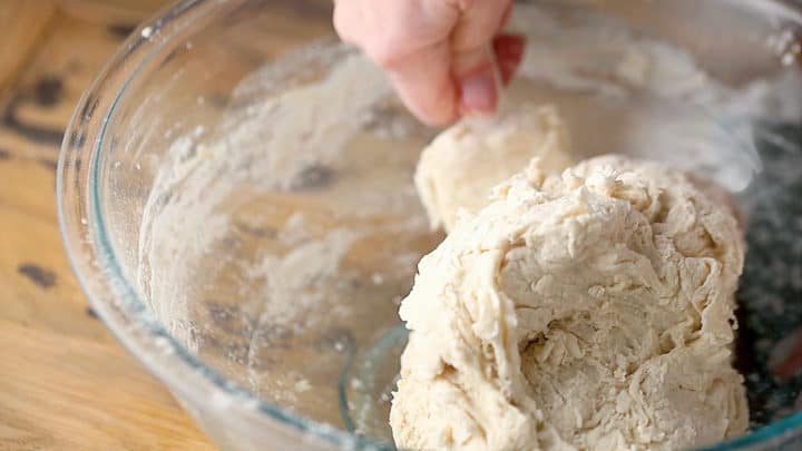 Mixing stiff bread dough with a silicone spatula.