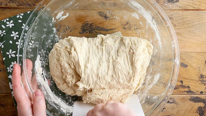 Folding bread dough.