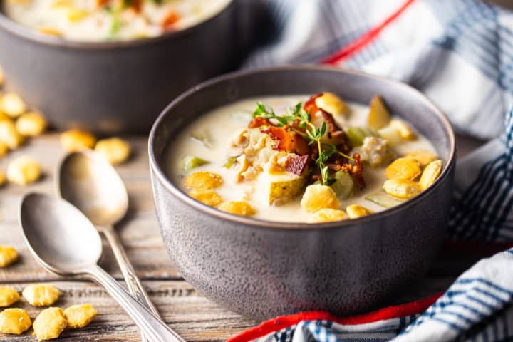 Easy clam chowder with bacon and soup crackers on top.