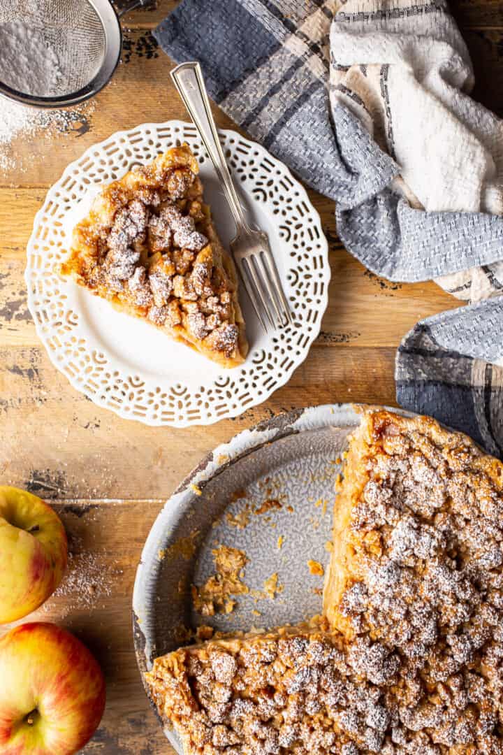 Overhead image of Dutch apple pie served on a distressed wooden surface.