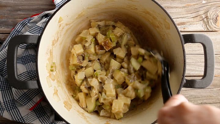 Vegetables, potatoes, and roux cooking in a large pot.