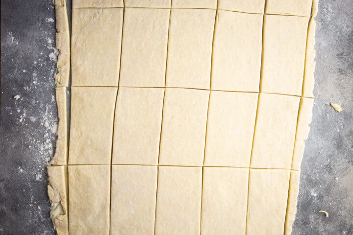 Trimming and cutting dough into rectangles.