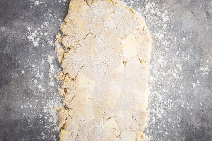 Rolling croissant dough into a long rectangle.