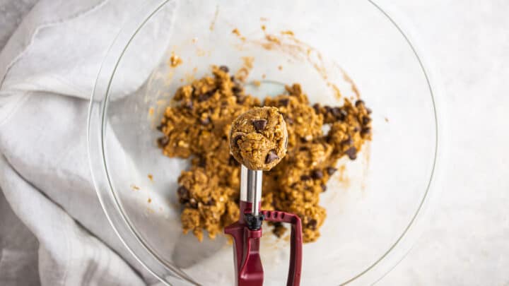 Scooping out protein cookie dough with a 1.5-tablespoon scoop.
