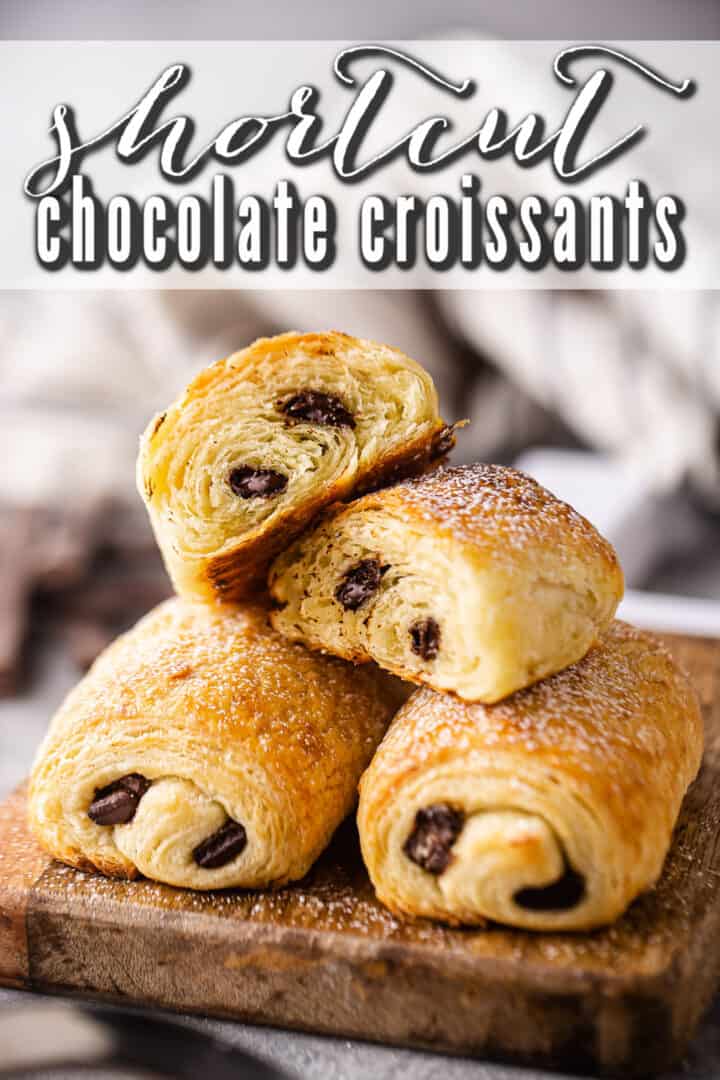 Chocolate croissants displayed on a wooden board with a text overlay that reads "Shortcut Chocolate Croissants."