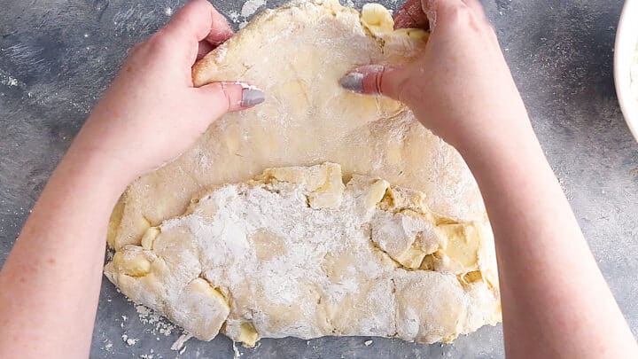 Folding croissant dough into thirds.