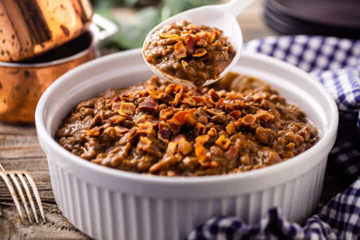 Homemade Bush's baked beans recipe, being served from a baking dish.