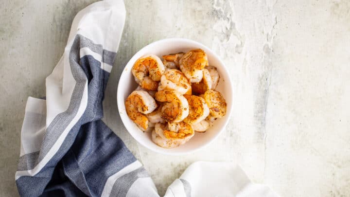 Grilled shrimp in a white bowl.