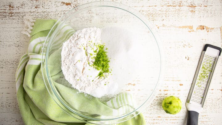 Dry ingredients for key lime cake in a large glass bowl.