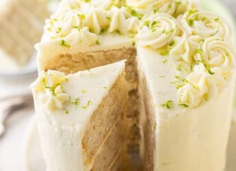 Key lime cake sliced and garnished with lime zest.