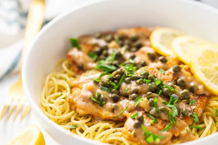 Best chicken piccata recipe, prepared and served with fresh parsley and lemon.