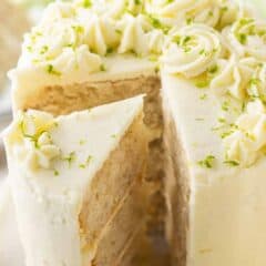 Key lime cake sliced and garnished with lime zest.