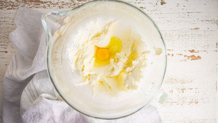 Adding egg to creamed butter and sugar.