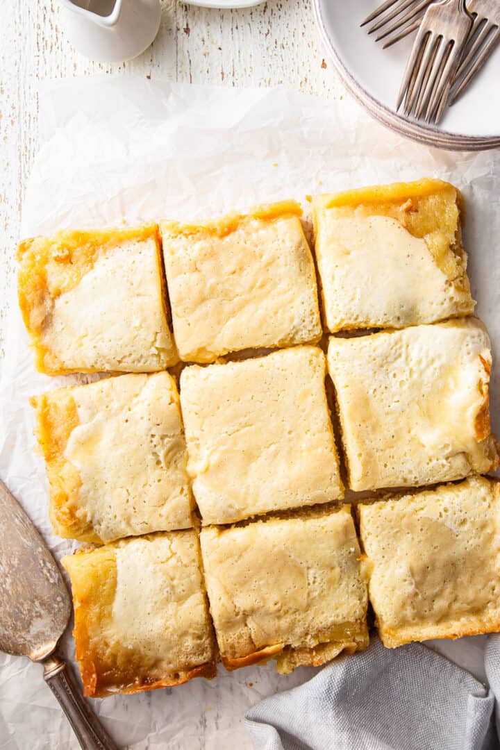 Gooey butter cake recipe, prepared, baked, and cut into squares.