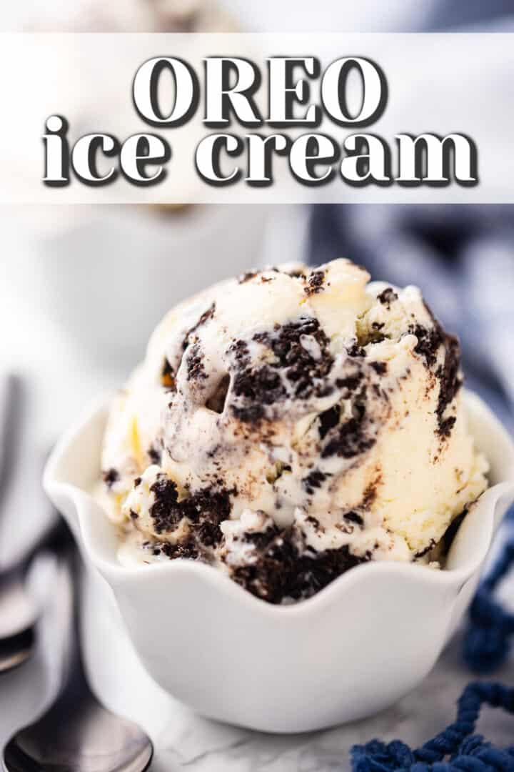 Cookies and cream ice cream scooped into a ruffled white porcelain bowl.