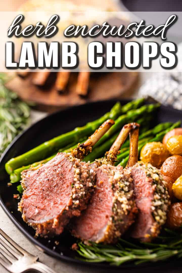 Lamb chop recipes prepared and served on a dark plate with fresh herbs.