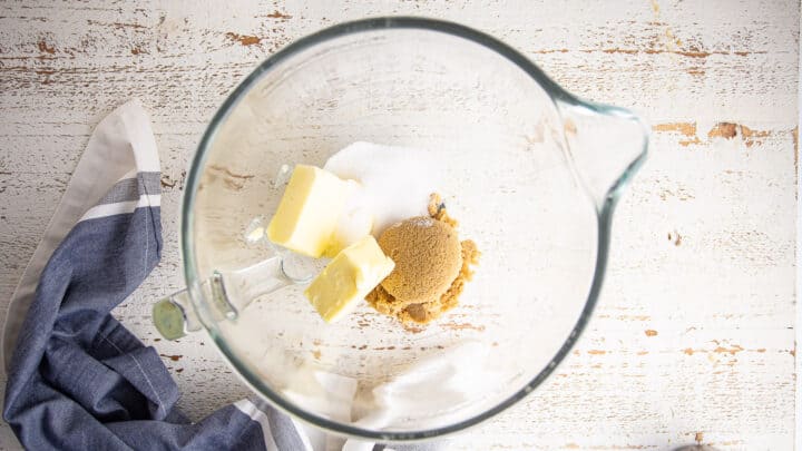 Light brown sugar, white sugar, and butter in a large glass mixing bowl.