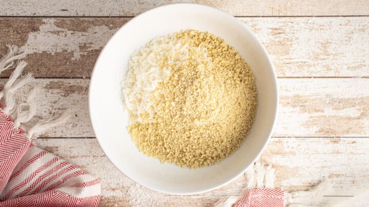 Shredded coconut and panko breadcrumbs in a shallow white bowl.
