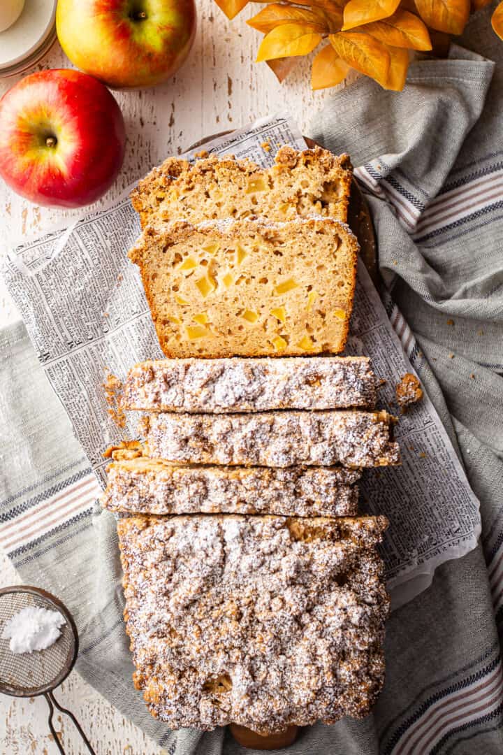 Apple cinnamon bread, topped with streusel and surrounded by fresh apples.