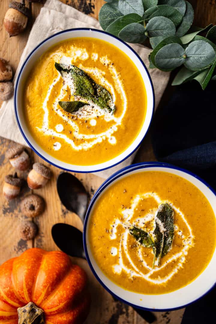 Recipe for pumpkin soup, prepared and presented on a distressed wooden tabletop.