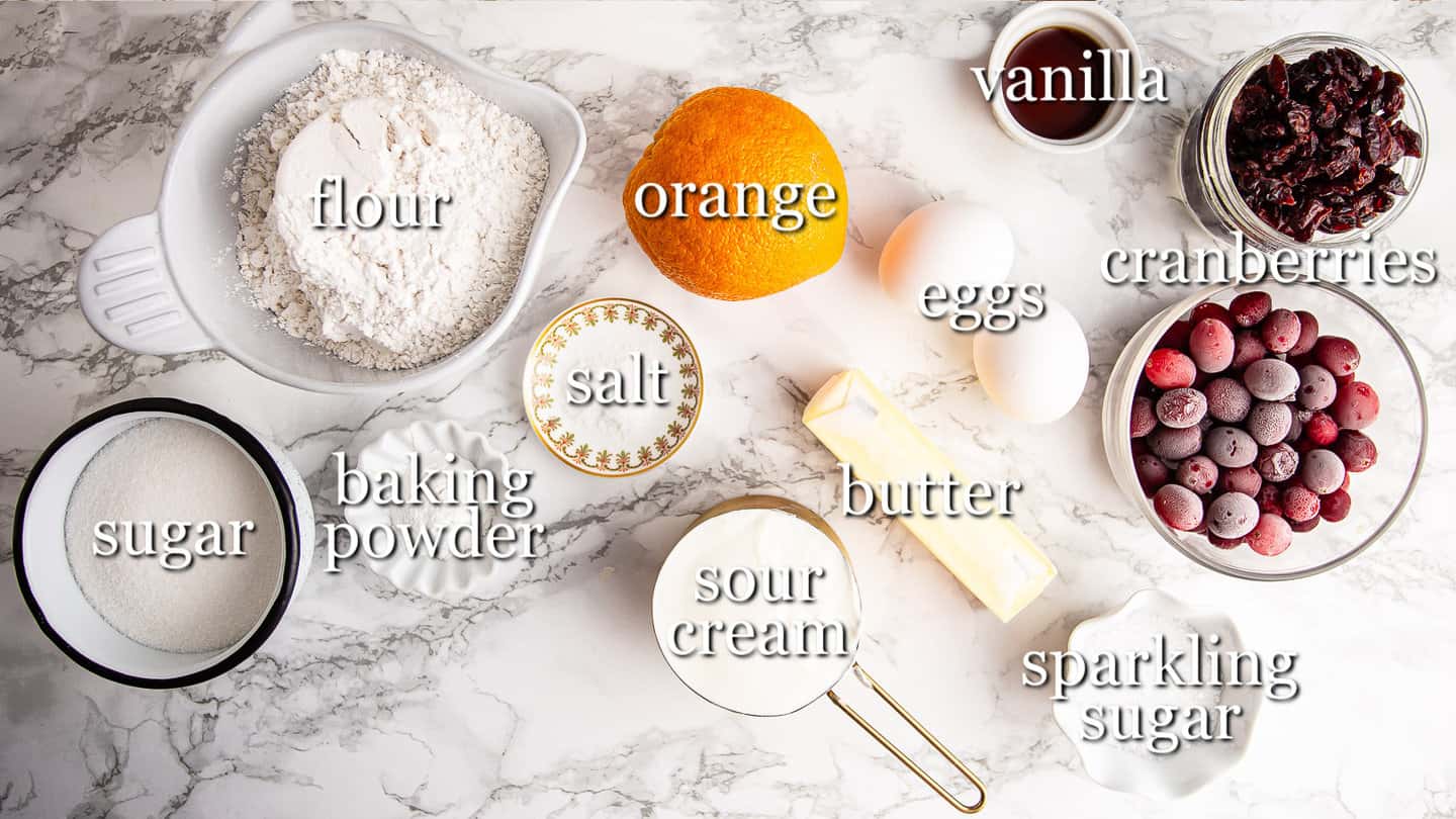 Ingredients for making cranberry orange muffins, with text labels.