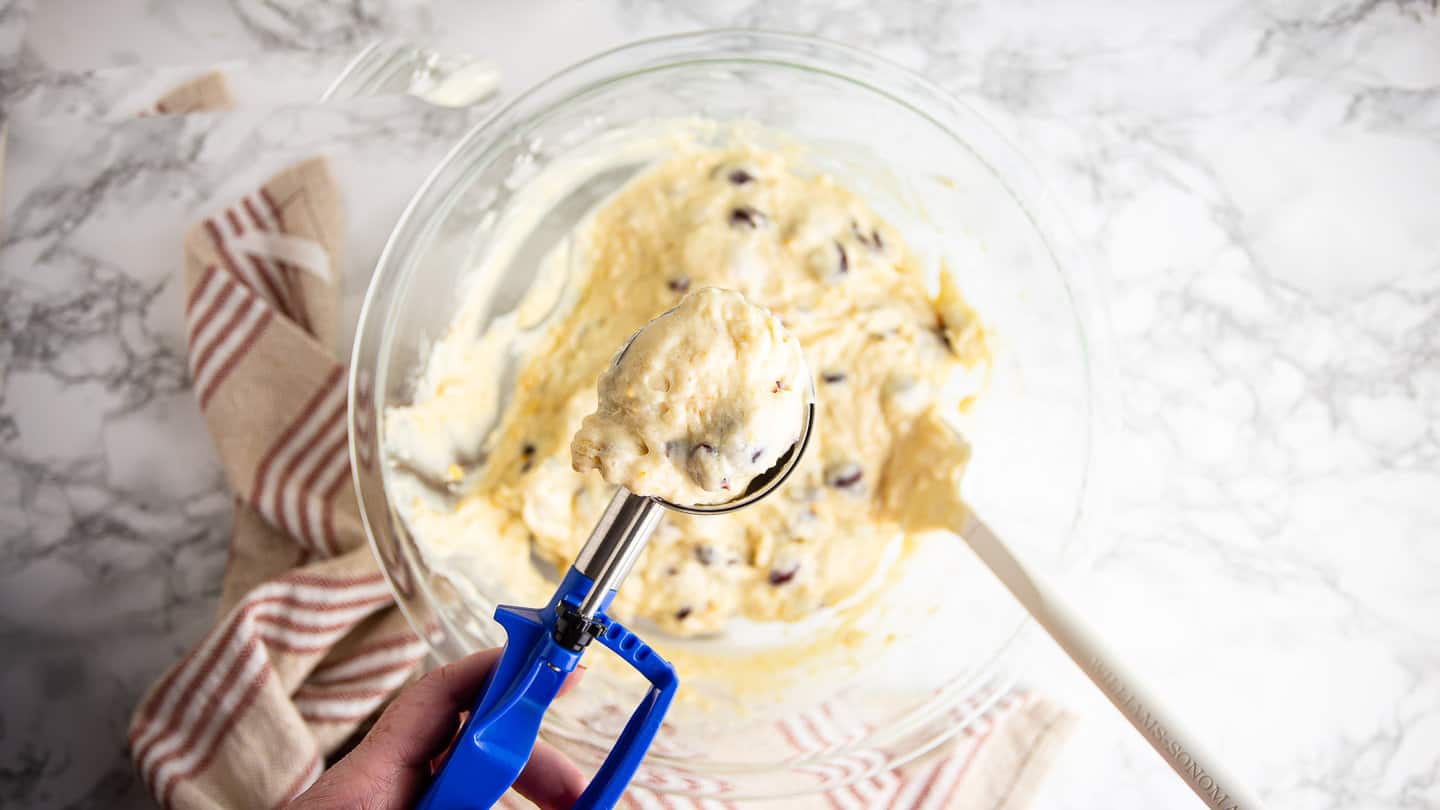Scooping muffin batter with a trigger scoop.