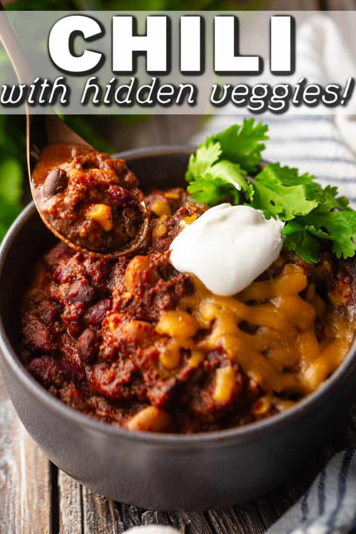 Best chili recipe ever, being spooned from the bowl with a text overlay that reads "Chili with Hidden Veggies."