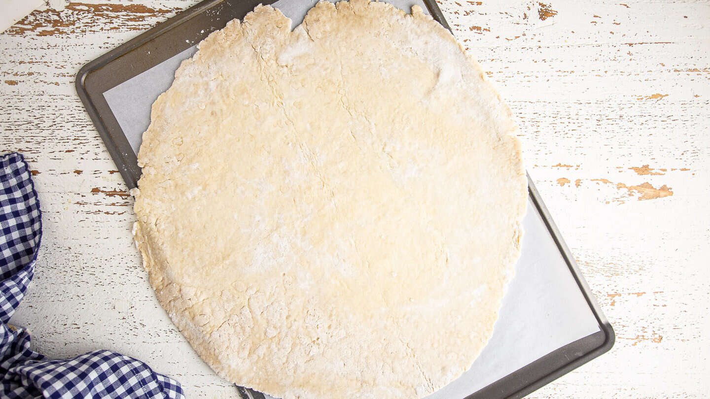 Apple galette pastry, rolled out to a large circle.