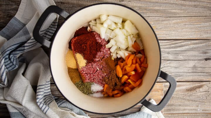 Ground meat, spices, and vegetables in a large pot.
