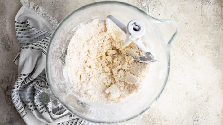 Butter and dry ingredients mixed together in a large bowl.