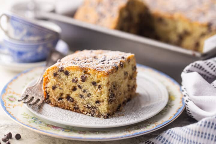 A square of easy homemade chocolate chip cake recipe, baked and served on a vintage plate.