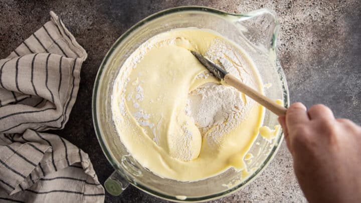 Folding flour gently into Genoise cake batter.