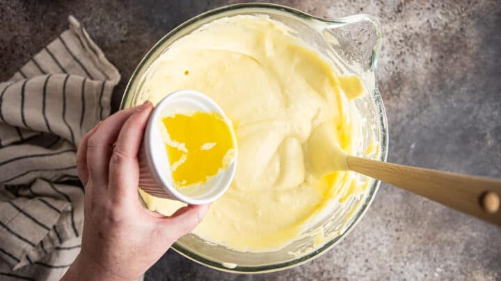 Adding melted butter to Genoise cake batter.