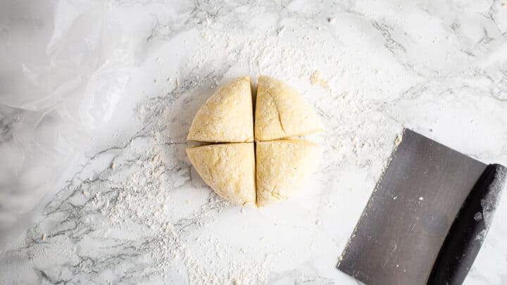 Dividing gnocchi dough into 4 equal portions.