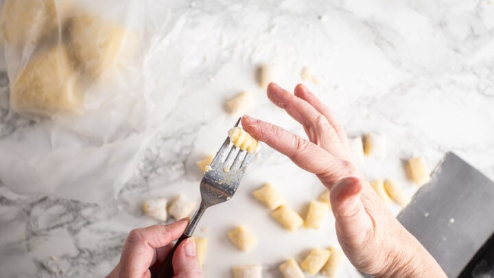 Shaping gnocchi with the back of a fork.