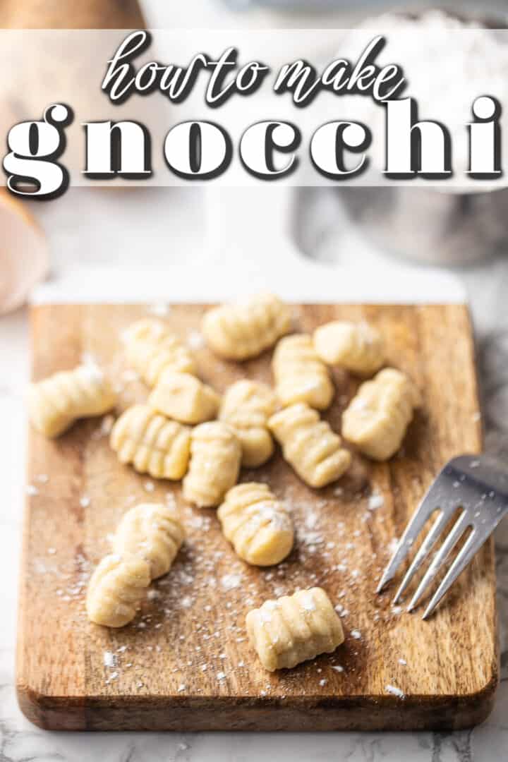 Gnocchi recipe being prepared on a wooden board with a fork.