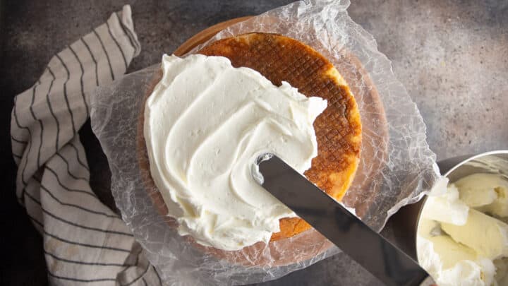 Frosting tiramisu cake with whipped cream.