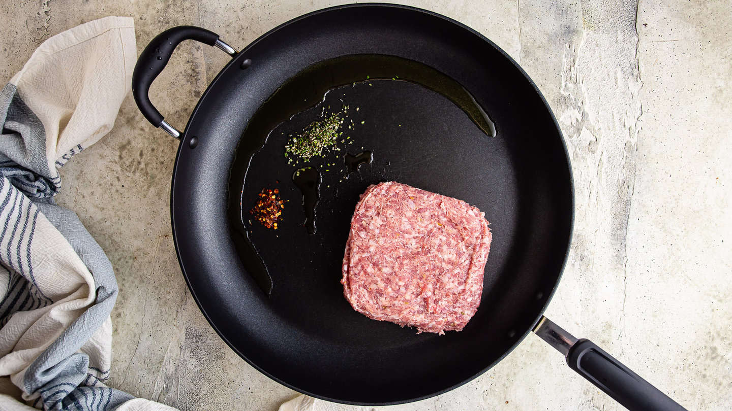 Bulk Italian sausage, olive oil, rosemary, and crushed red pepper in a large skillet.