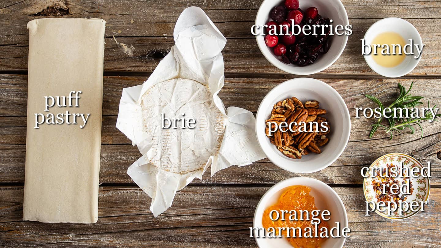 Ingredients for making baked brie in puff pastry, with text labels.