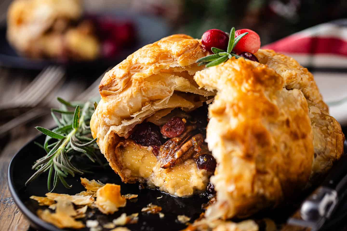 Baked brie puff pastry with wintry fruits, nuts, and herbs.