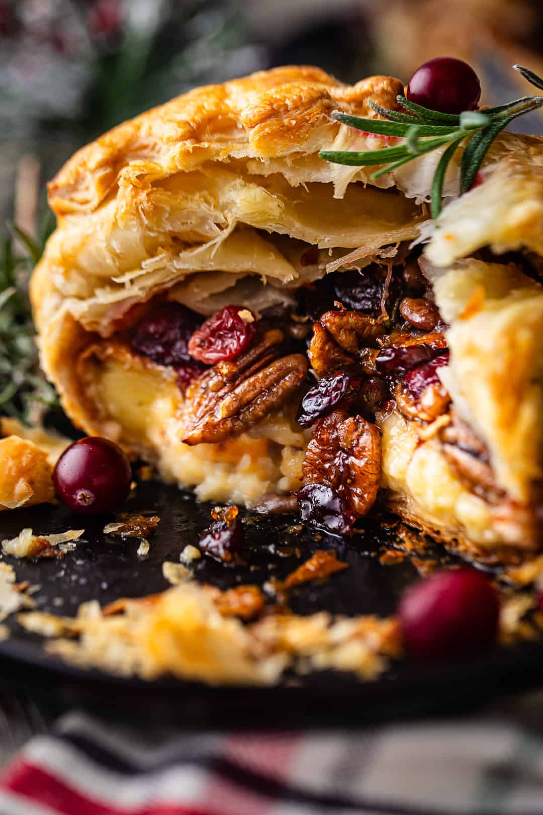 Baked brie recipe, cut open to display the oozy filling inside.