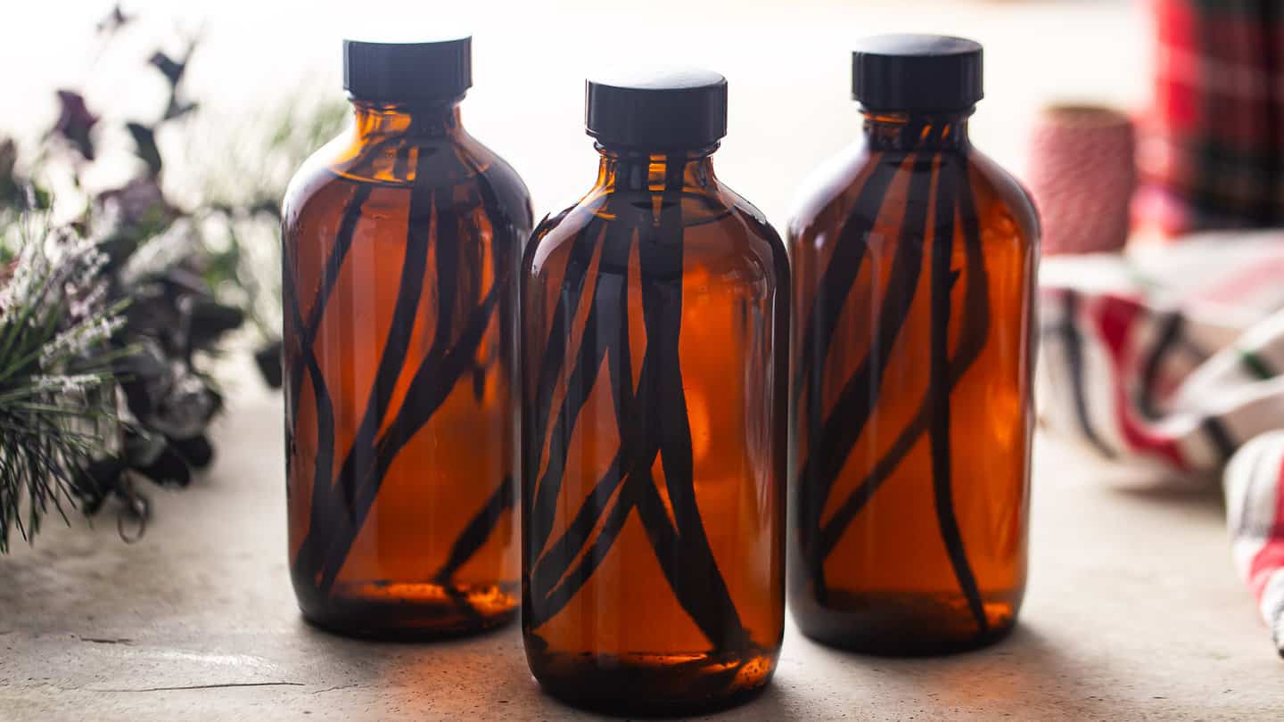 Bottles of homemade vanilla extract infusing over time.