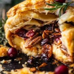 Baked brie recipe, cut open to display the oozy filling inside.