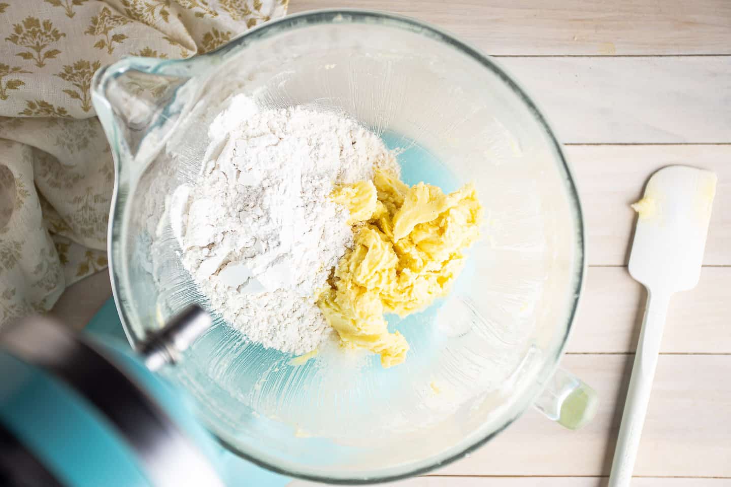 Adding flour and salt to butter cookie dough.