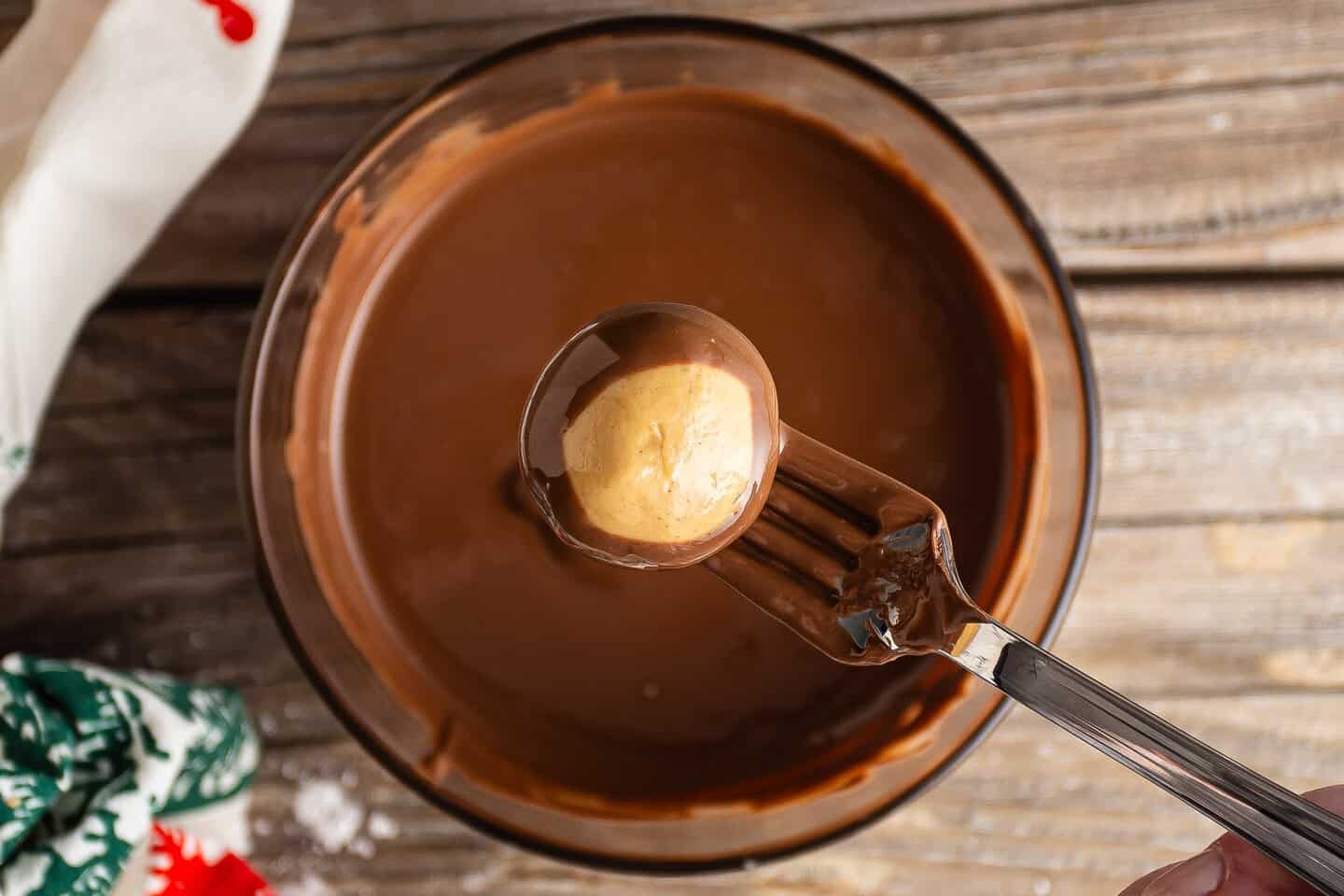 Dipping buckeye balls in melted chocolate.