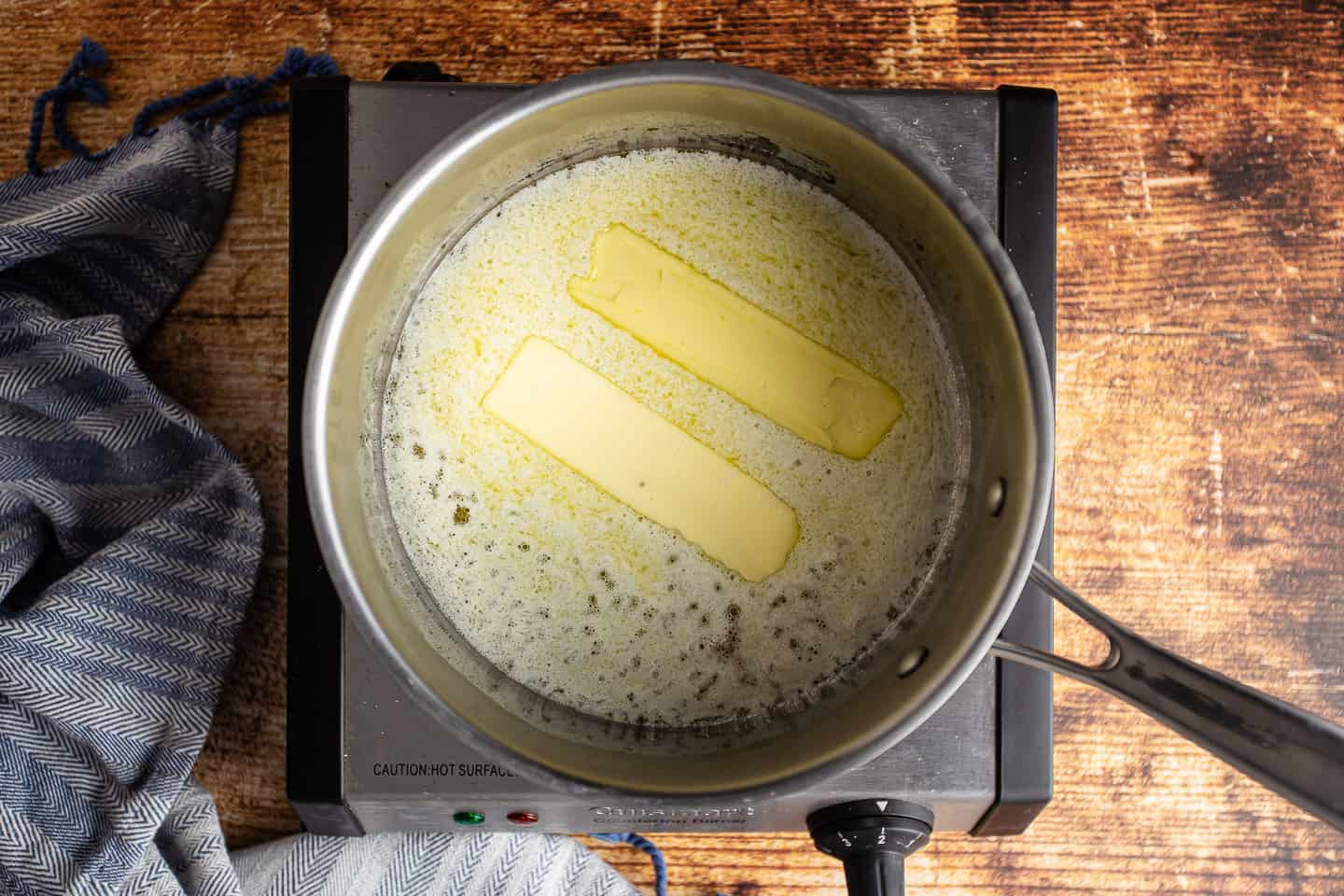Melting butter in a small stainless pot.